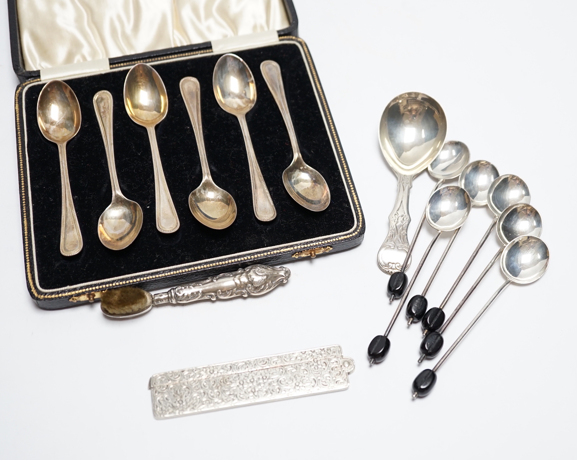 Sundry small silver including a Victorian caddy spoon, London, 1845, a folding comb, handled toothbrush and various coffee spoons.